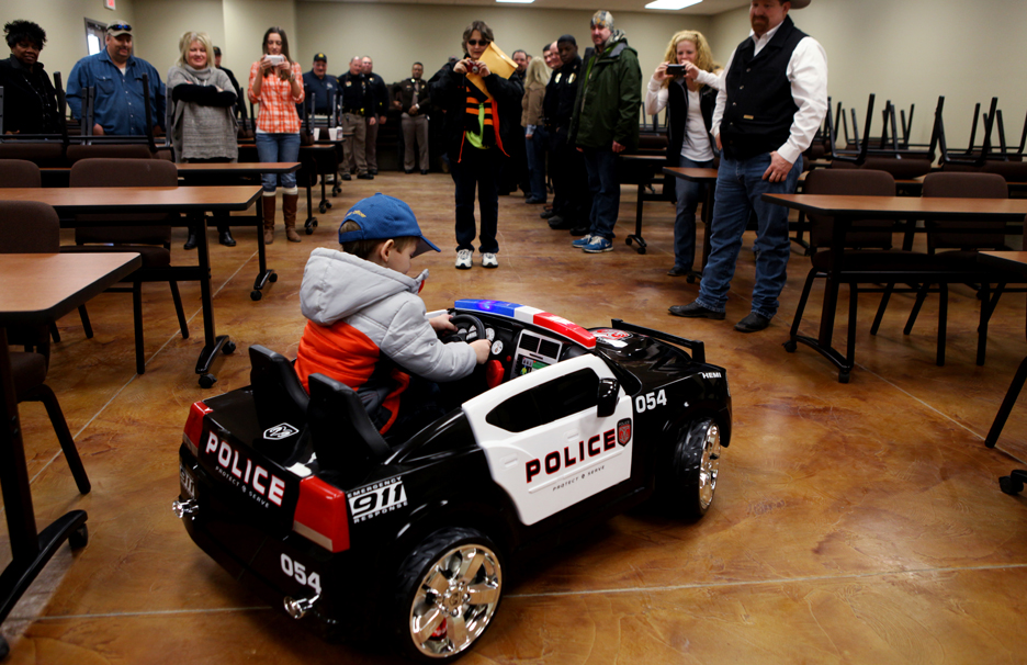 Lil D in his own "police car."