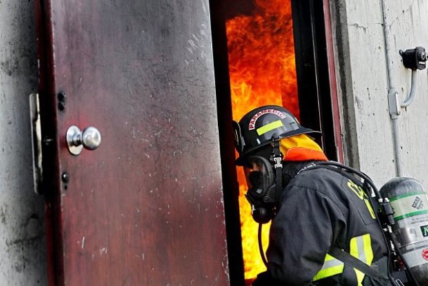 Trevor Stanley, a county academy instructor and firefighter with CKFR, watches area volunteers train. Instructors are working to revamp the academy after a high failure rate. (Rachel Anne Seymour / Kitsap Sun)