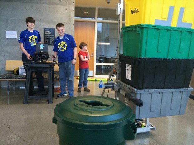 Members of the Bainbridge High School robotics team, known as the Spartonics, show off this year’s robot during an open house this week. The robot is known as GAEA. (Rachel Anne Seymour / Kitsap Sun)