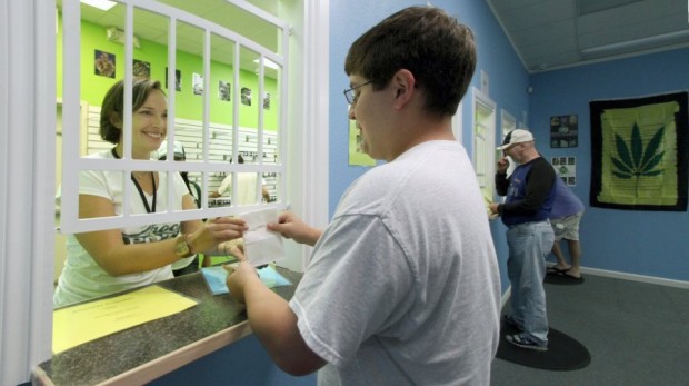 Aaron Boyington, of Port Orchard, was the first to make a purchase Sunday morning at Crockpot, Kitsap County’s first retail marijuan store located at Bethel and Sedgwick in South Kitsap. (Steve Zugschwerdt / Special to the Kitsap Sun)